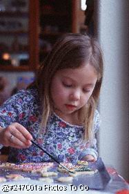 Girl decorating Christmas cookies